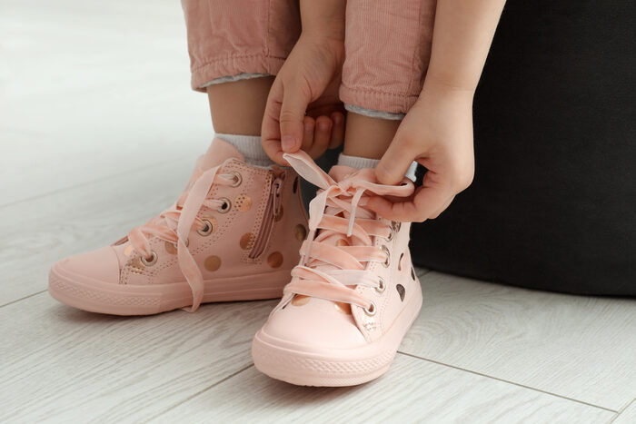 Someone tying their own shoelaces