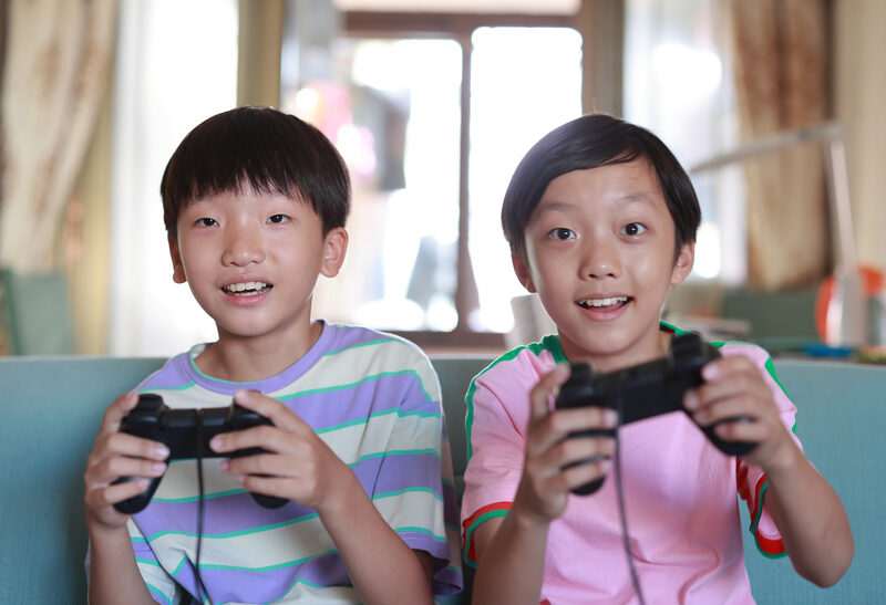 Two children concentrating on a game