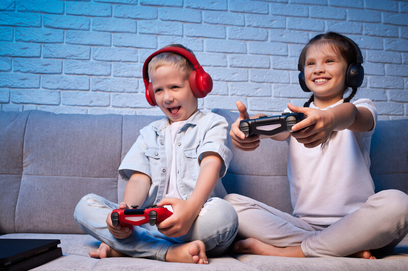 A child in headphones playing with a controller