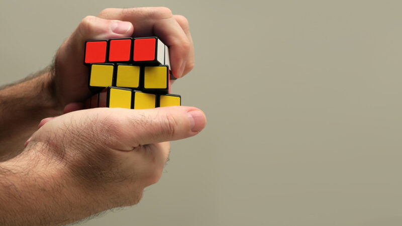 Hands solving a Rubik's cube